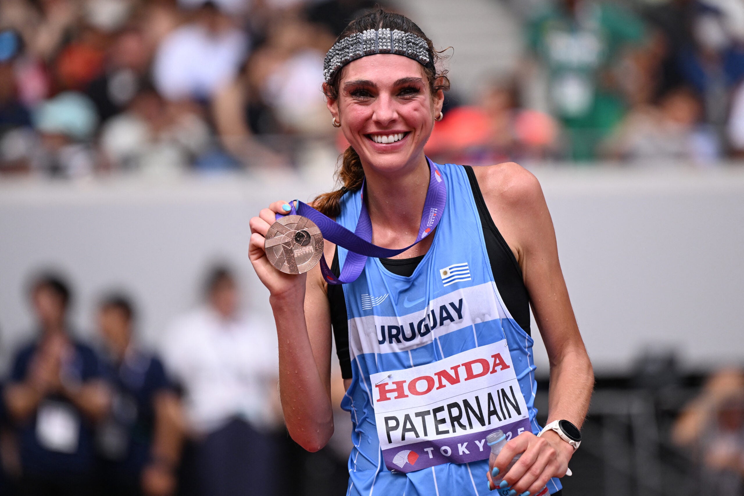 Third-placed Uruguay's athlete Julia Paternain celebrates with her bronze medal after competing in the women's marathon final during the World Athletics Championships in Tokyo on September 14, 2025.