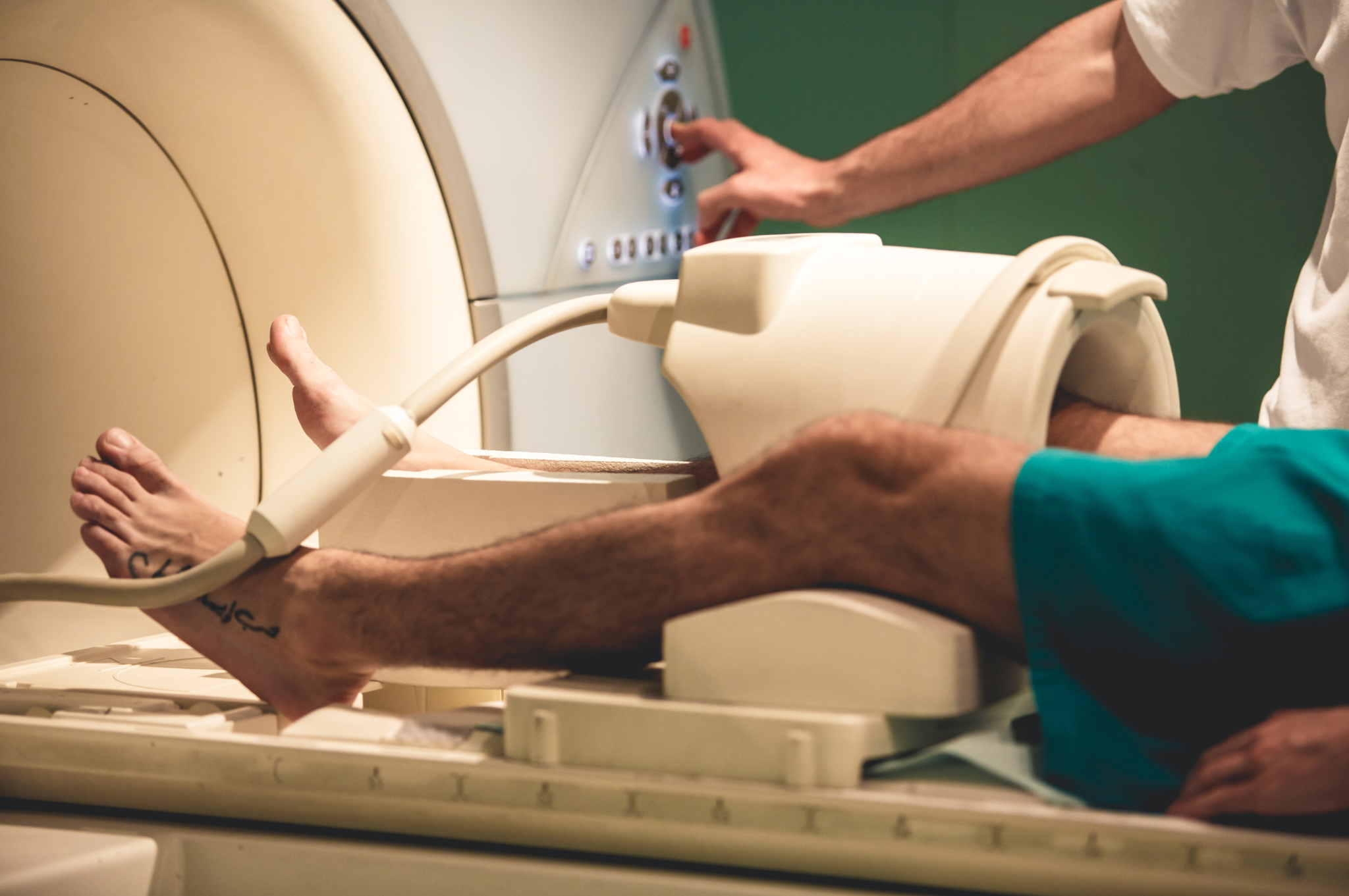 a man's legs going into an MRI machine